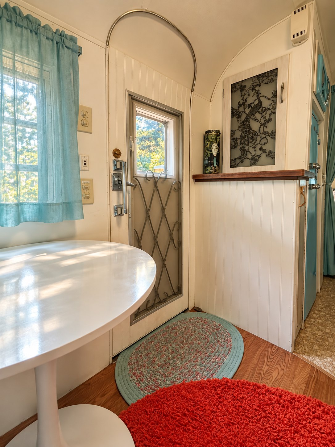 The entry with a tulip table and round rugs